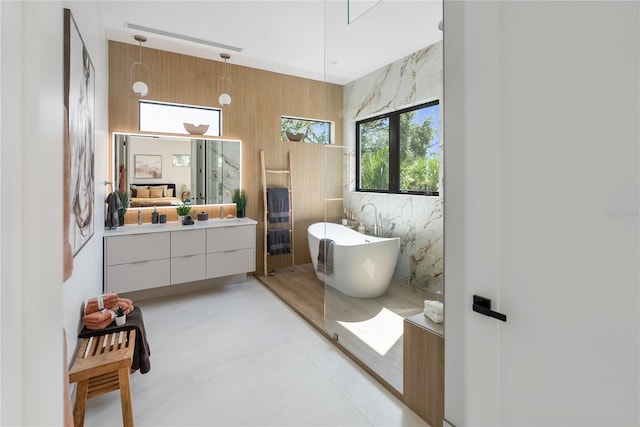 bathroom featuring vanity and shower with separate bathtub