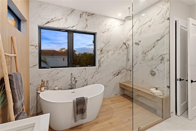 bathroom featuring tile walls and separate shower and tub