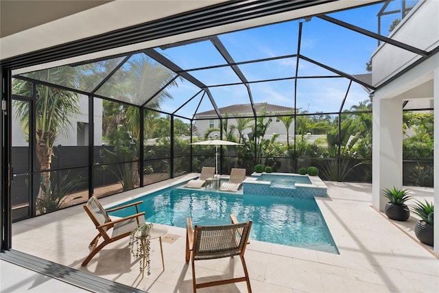 view of pool with an in ground hot tub, a patio area, and glass enclosure