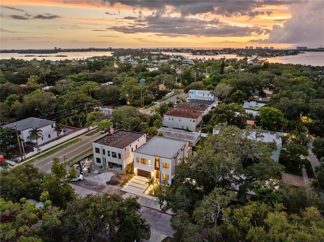 aerial view at dusk with a water view