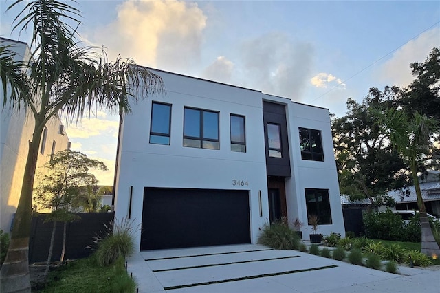 3464 Camino Real, Sarasota, FL 34239 - view of front of house with stucco siding, a garage, and concrete driveway