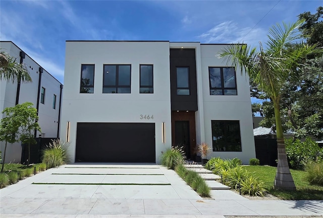 3464 Camino Real, Sarasota, FL 34239 - contemporary home with stucco siding, driveway, and a garage