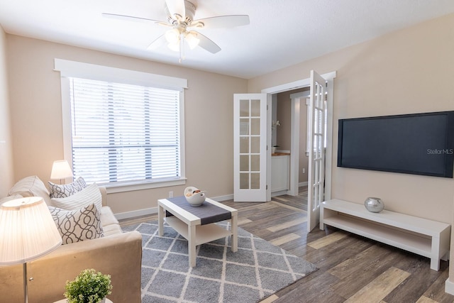 living room with french doors, dark wood-type flooring, and ceiling fan