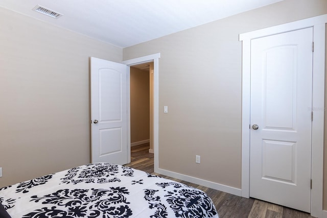 bedroom with dark hardwood / wood-style flooring