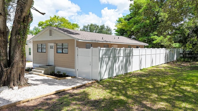 view of outbuilding featuring a lawn