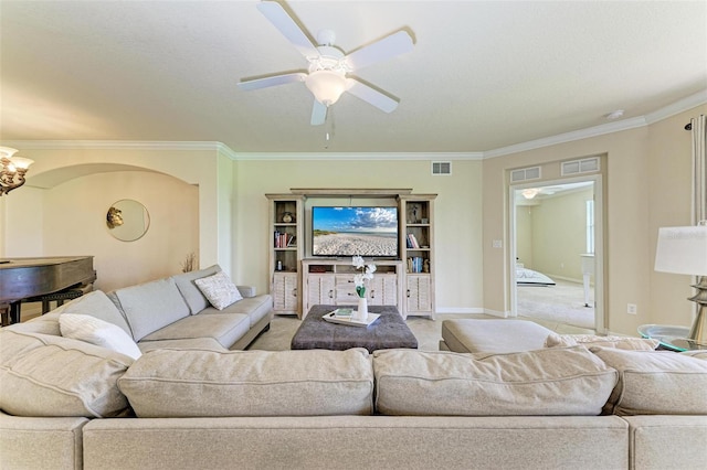 living room featuring crown molding, ceiling fan, and carpet