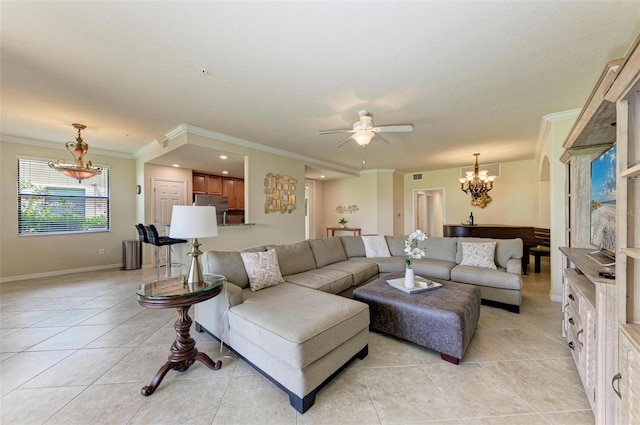 living room with ceiling fan with notable chandelier, light tile patterned floors, and crown molding