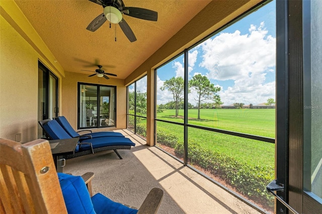 sunroom / solarium featuring ceiling fan