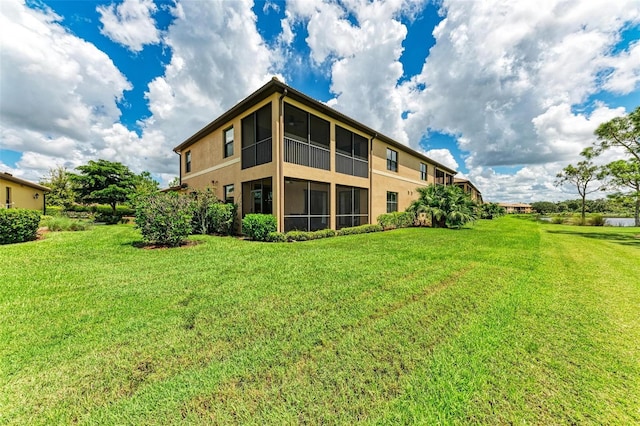 rear view of house featuring a lawn