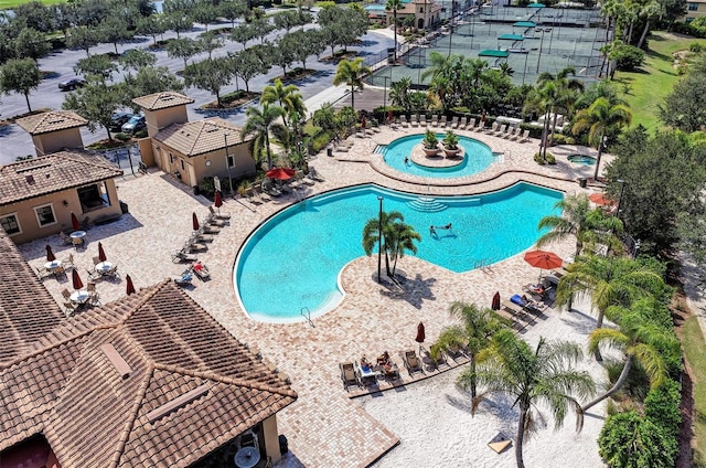 view of pool featuring a hot tub and a patio