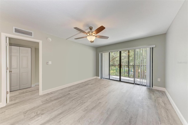 empty room featuring light wood-type flooring and ceiling fan