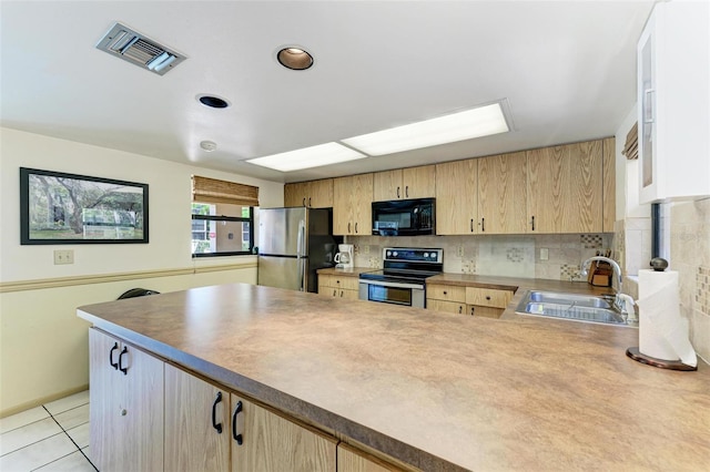 kitchen with stainless steel appliances, sink, light brown cabinets, and tasteful backsplash