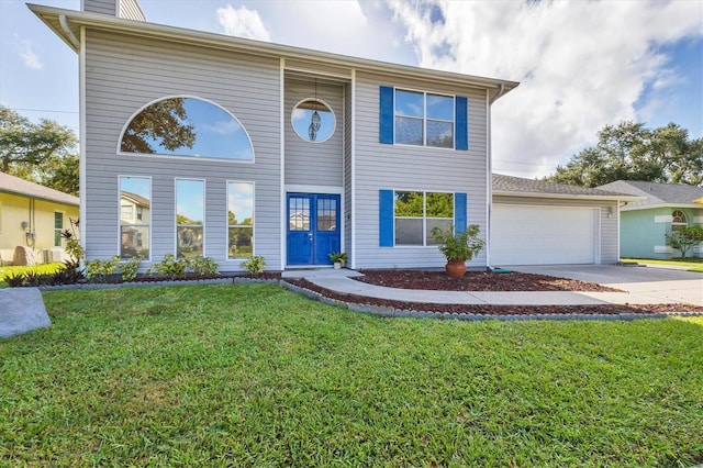 view of front of house with a garage and a front lawn