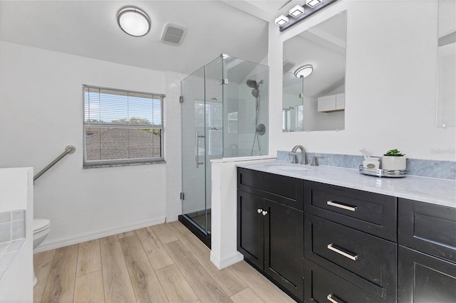 3125 57th Avenue Cir E, Bradenton, FL 34203 - bathroom with vanity, a stall shower, and wood finished floors