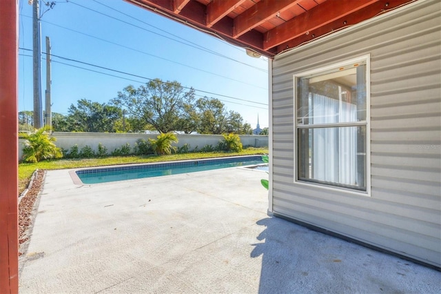 view of pool with a fenced in pool, a patio area, and fence