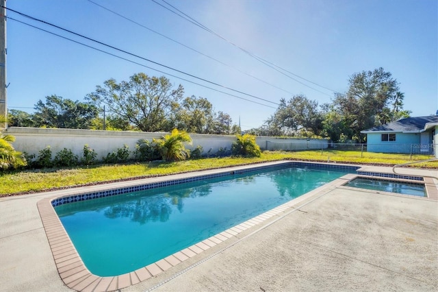 view of pool with a fenced in pool, a fenced backyard, a lawn, and a patio