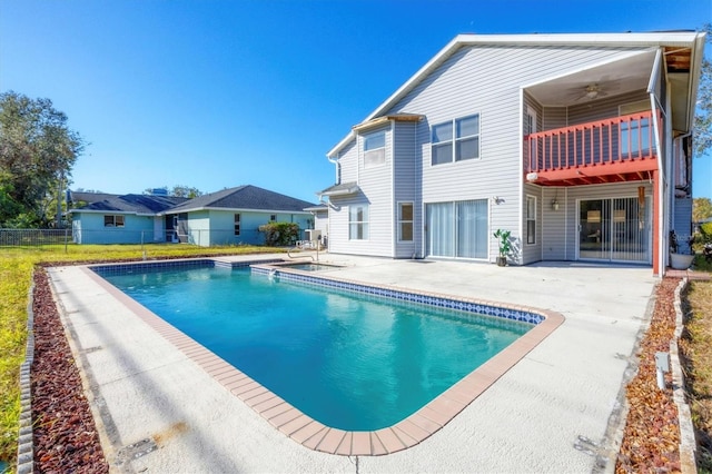 view of pool featuring a fenced in pool, a patio, ceiling fan, an in ground hot tub, and fence