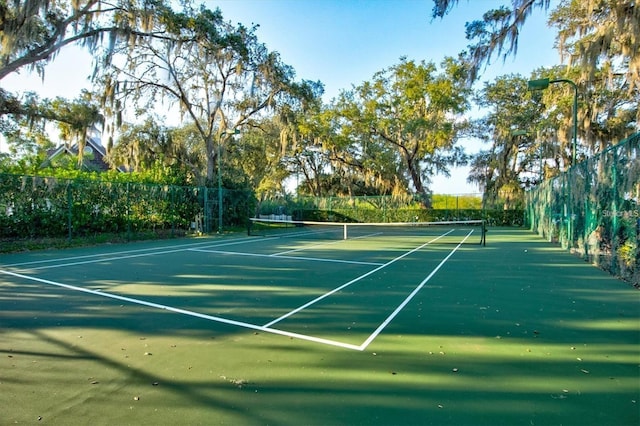 view of tennis court featuring fence