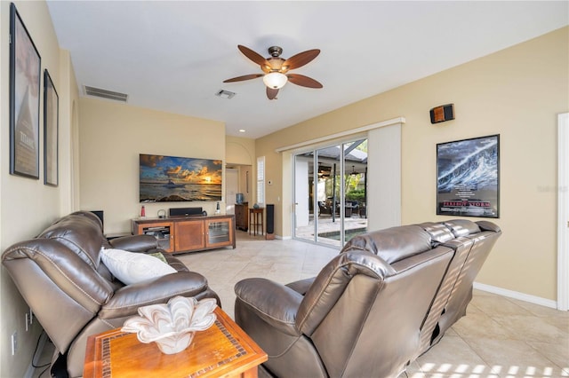 living area with light tile patterned floors, visible vents, baseboards, and ceiling fan