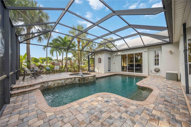 view of pool with central air condition unit, glass enclosure, a pool with connected hot tub, and a patio