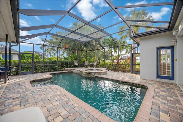 view of pool featuring glass enclosure, a patio area, and a pool with connected hot tub