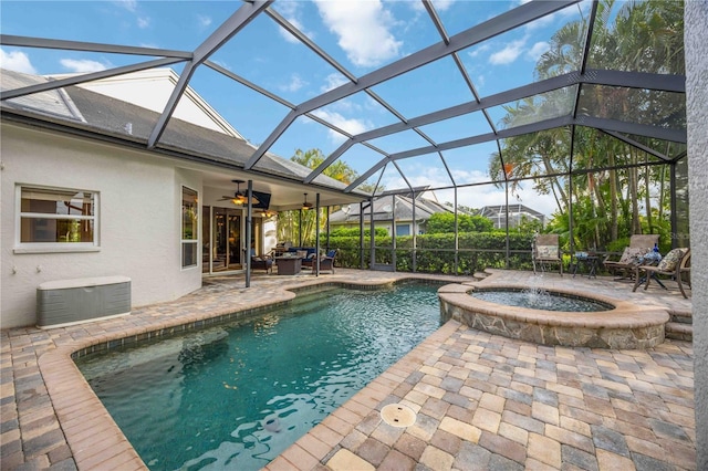 view of pool featuring a patio area, a lanai, a pool with connected hot tub, and a ceiling fan