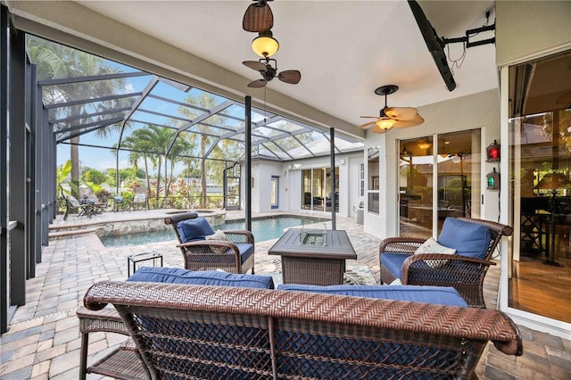 view of patio / terrace with ceiling fan, an outdoor living space with a fire pit, a lanai, and a pool with connected hot tub