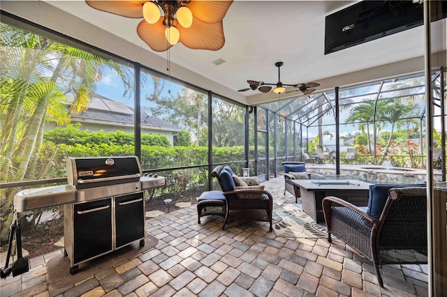 sunroom featuring a ceiling fan