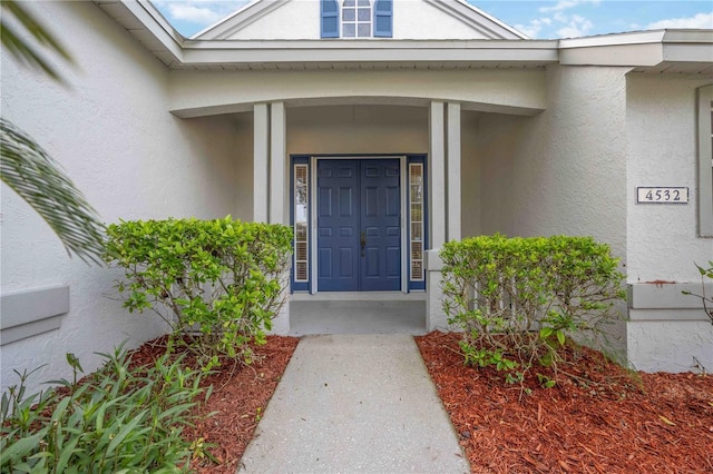 doorway to property with stucco siding