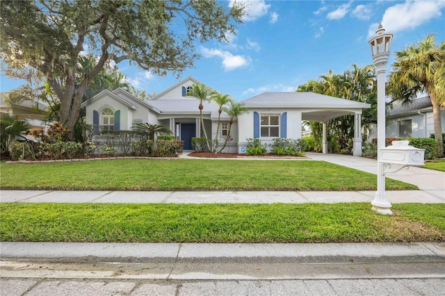 ranch-style home with a carport, stucco siding, concrete driveway, and a front yard