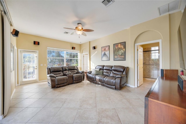 living room featuring light tile patterned flooring, a ceiling fan, and visible vents