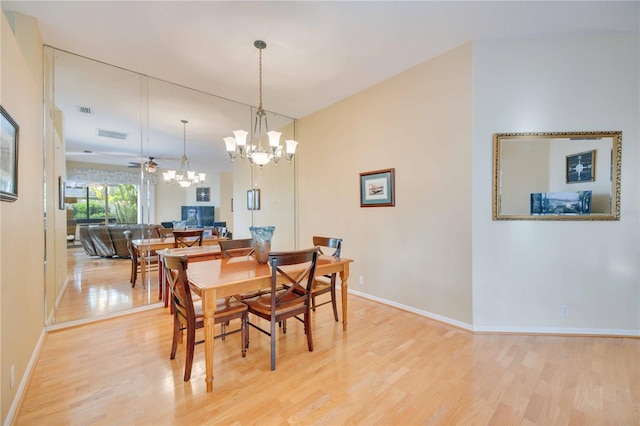 4532 Shark Dr, Bradenton, FL 34208 - dining room with baseboards, light wood-style flooring, and a notable chandelier