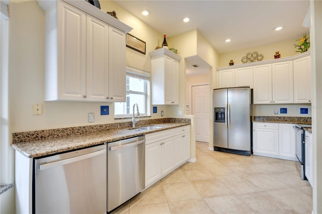 4532 Shark Dr, Bradenton, FL 34208 - kitchen with a sink, white cabinets, light stone countertops, and stainless steel appliances