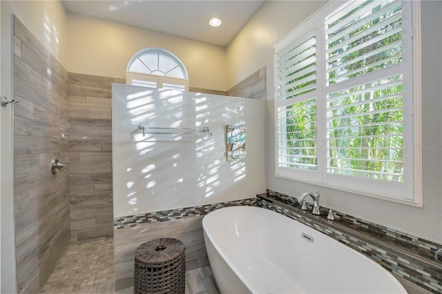 4532 Shark Dr, Bradenton, FL 34208 - bathroom with a walk in shower and a freestanding bath