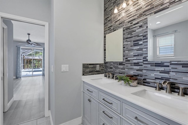 bathroom featuring plenty of natural light, vanity, and tasteful backsplash