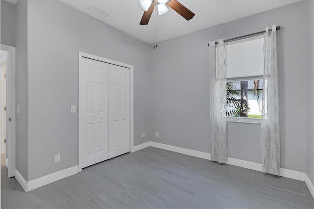 unfurnished bedroom with hardwood / wood-style floors, a closet, and ceiling fan