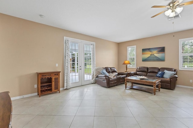 living room featuring ceiling fan, light tile patterned floors, and french doors