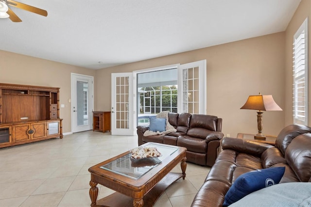 living room featuring a wealth of natural light, french doors, ceiling fan, and light tile patterned floors