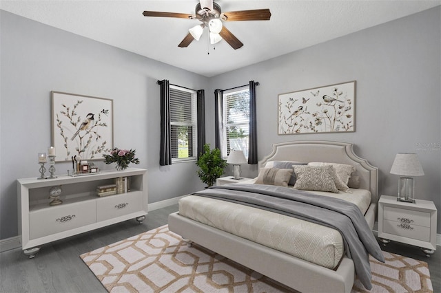 bedroom featuring dark hardwood / wood-style flooring and ceiling fan