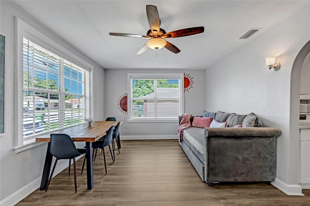 living room featuring hardwood / wood-style floors and ceiling fan