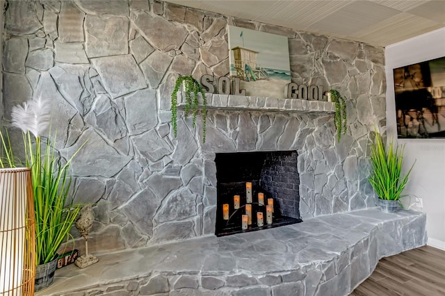 interior details featuring a fireplace and wood-type flooring