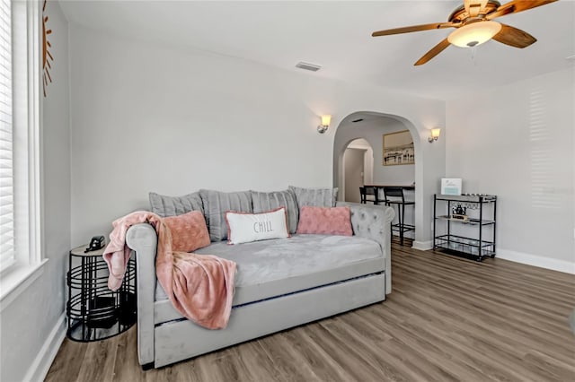 living room with ceiling fan and hardwood / wood-style floors