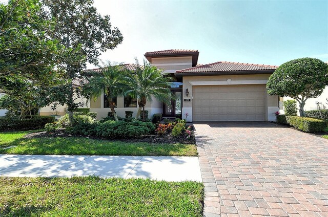 mediterranean / spanish-style home with a garage