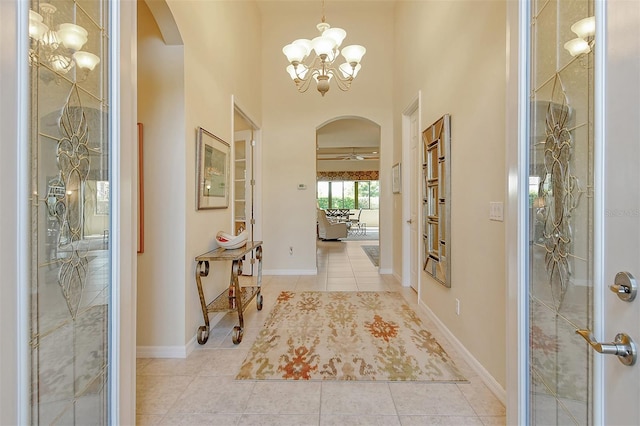 entryway featuring light tile patterned floors and a chandelier