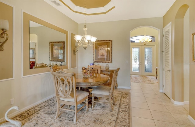 dining room featuring arched walkways, light tile patterned flooring, visible vents, and an inviting chandelier