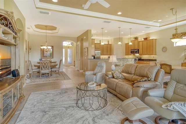 living room featuring visible vents, baseboards, a raised ceiling, light tile patterned flooring, and recessed lighting