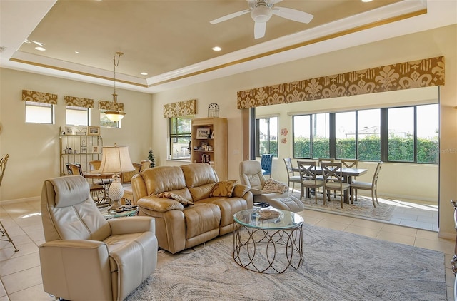 living room featuring light tile patterned floors, baseboards, ceiling fan, a tray ceiling, and recessed lighting