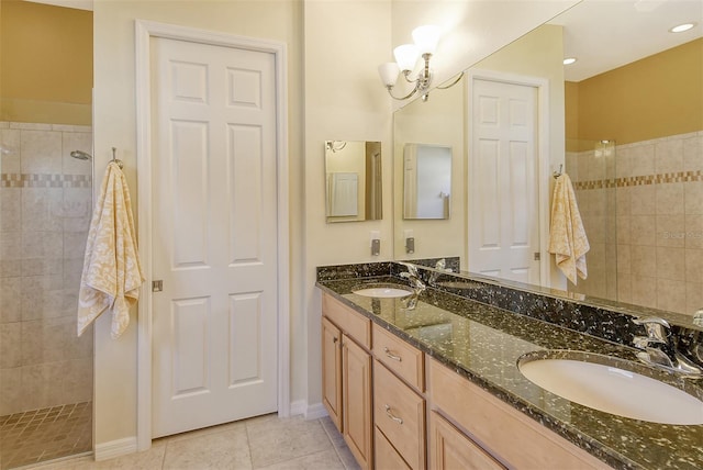 bathroom featuring tiled shower, vanity, and tile patterned floors