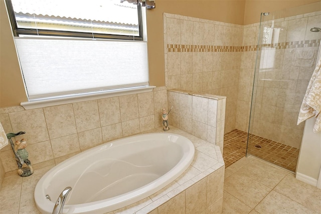 bathroom featuring plus walk in shower and tile patterned flooring