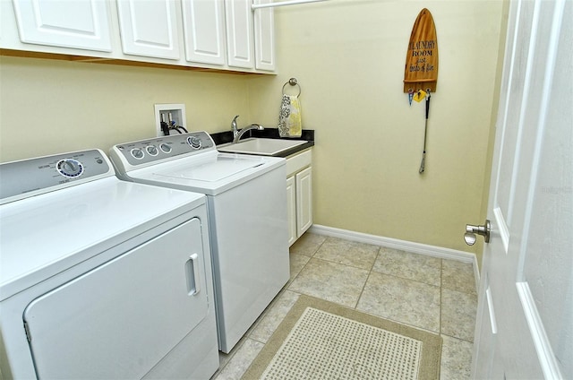 washroom featuring cabinets, independent washer and dryer, sink, and light tile patterned flooring